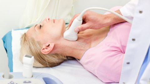 Woman receiving ultrasound test on neck