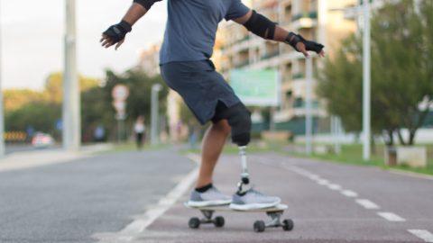 Man with prosthetic leg skateboarding