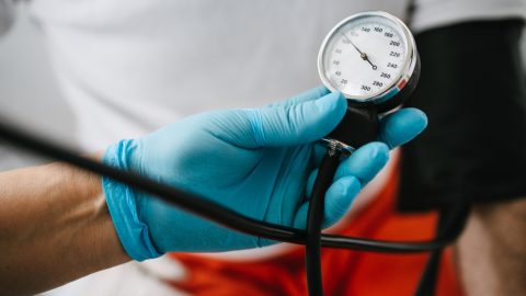 Doctor holding blood pressure meter