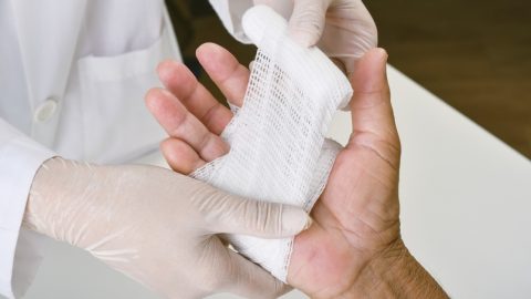 doctor bandaging a hand