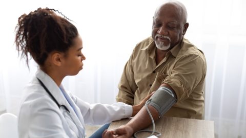 Doctor checking on older man