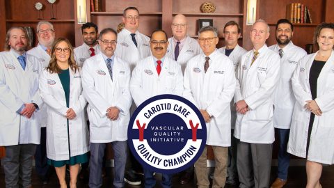 The VSA team and a badge that says Carotid Care Quality Champion, Vascular Quality Initiative